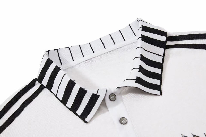 White men's polo shirt with black piano-key collar and trim, featuring a vintage music-inspired graphic style