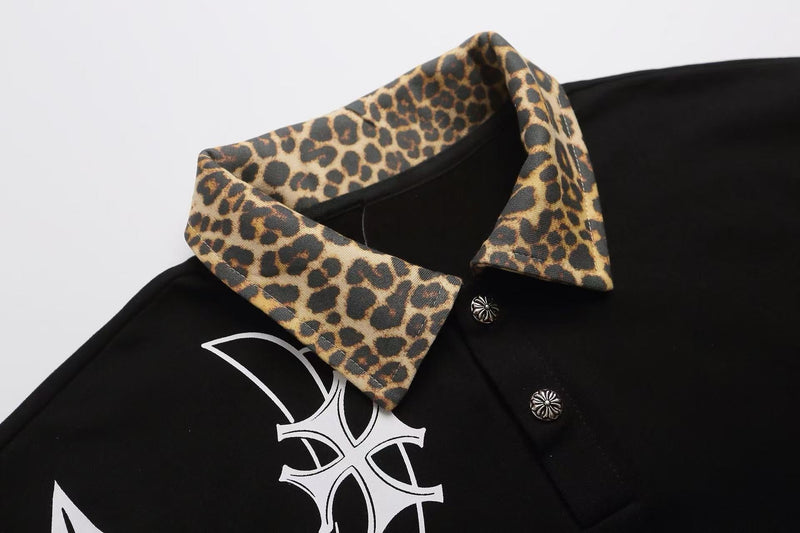 Black polo shirt with leopard-print collar and gothic cross graphic, styled in Y2K streetwear fashion
