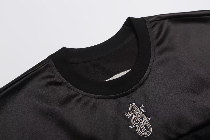 Black mesh football jersey T-shirt with embroidered gothic logo and ribbed crew neck details