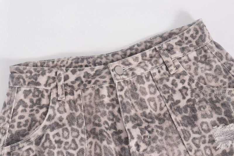 Close-up of leopard print denim waistband with button and belt loops