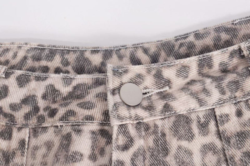 Close-up of leopard print denim waistband and snap button detail