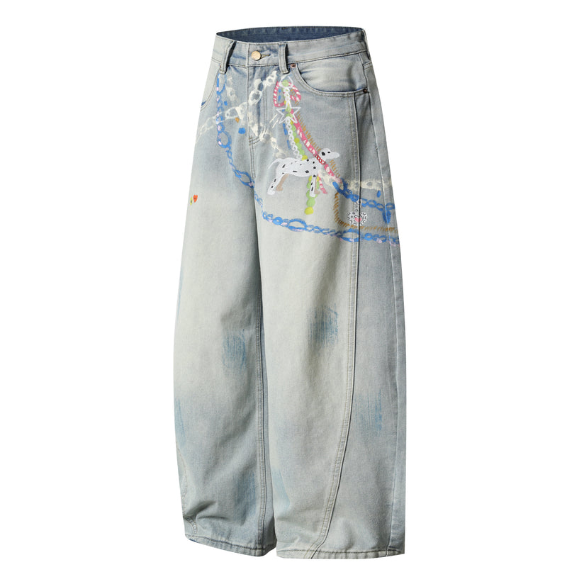 Angled front view of light wash wide-leg denim pants with colorful painted graphic