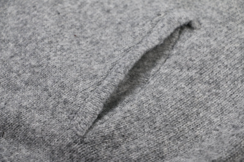 Close-up of gray knit hoodie fabric and seam detail