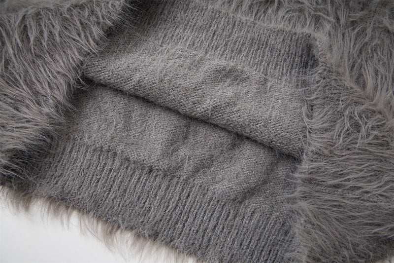 Close-up of gray sweater ribbed knit cuff inside the shaggy fur