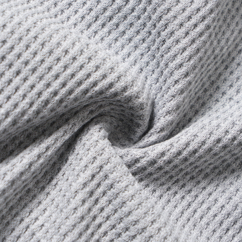 Close-up of the gray waffle knit fabric gathered in folds