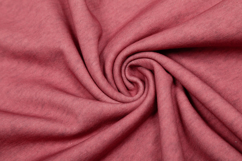 Close-up of pink hoodie fabric folded to show soft knit texture