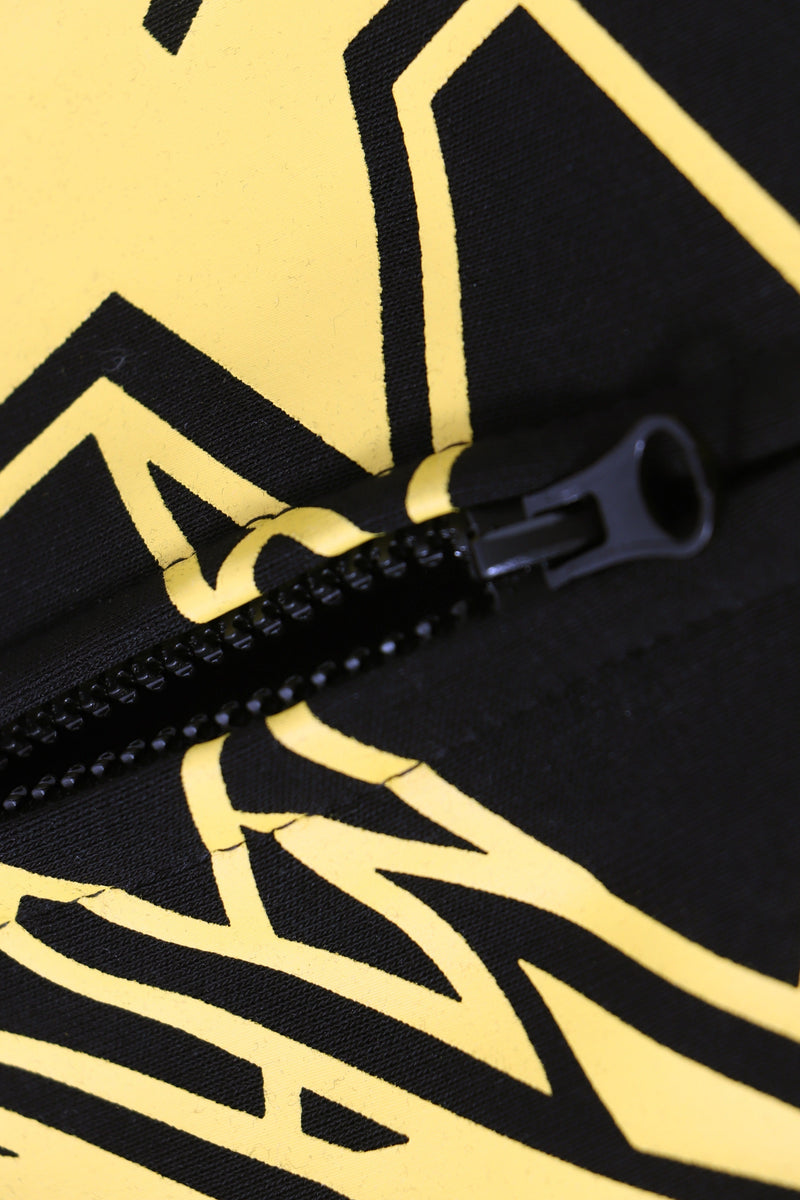Close-up of black zipper and yellow print on black hoodie fabric