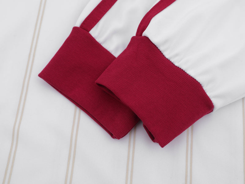 Close-up of maroon ribbed sleeve cuffs on the white soccer jersey
