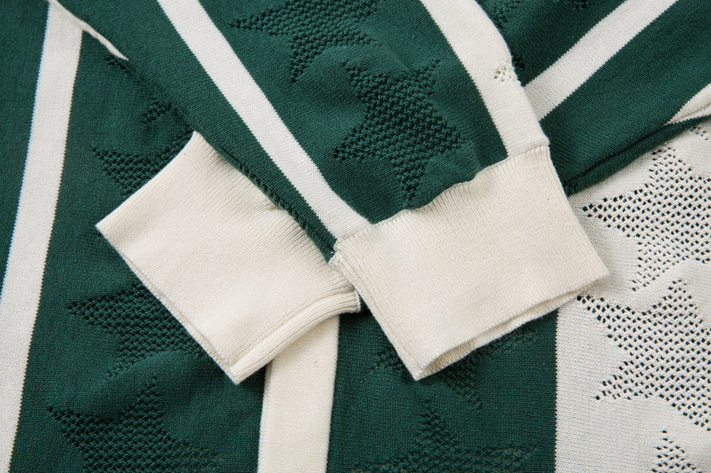 Close-up of cream cuffs on green striped knit polo shirt