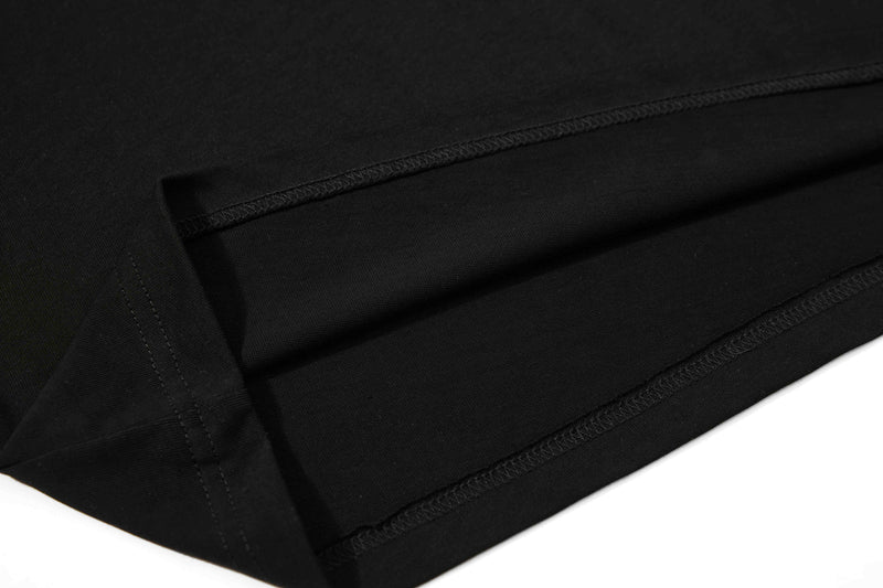 Close-up of black cotton polo tee with clean stitched seams and folded hem detail