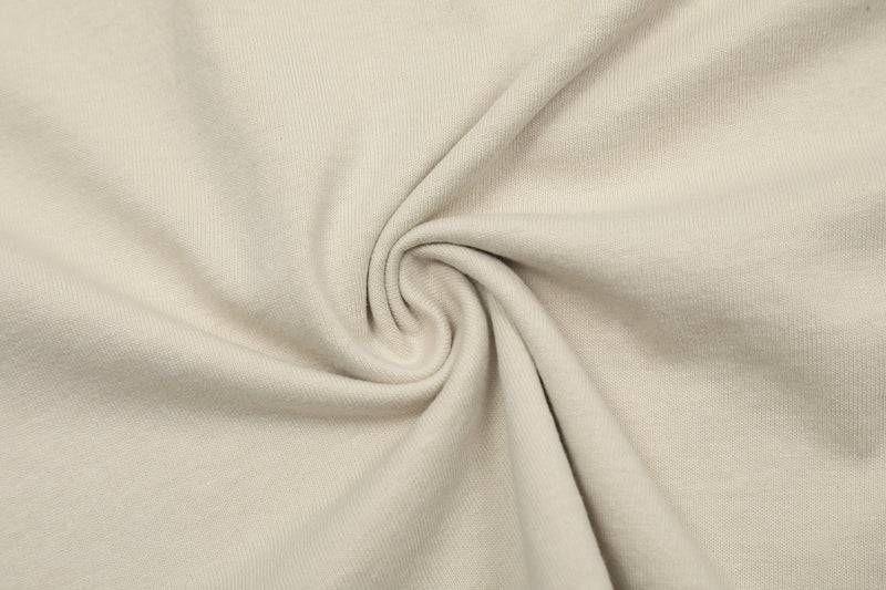 Cream oversized washed graphic tee fabric with soft vintage texture and relaxed drape
