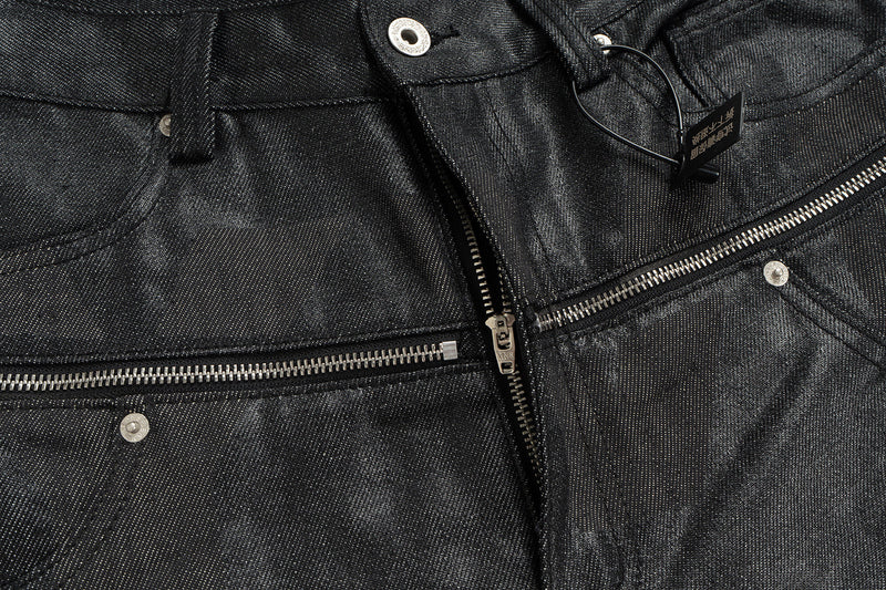 Close-up of black coated denim front with double zipper waist detail