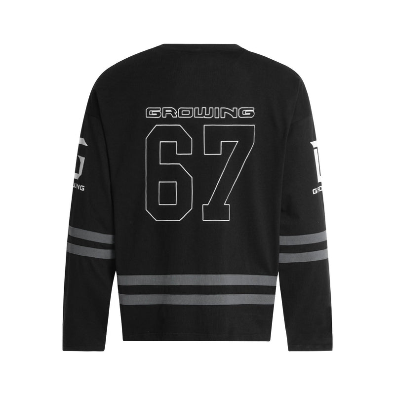 Black hockey jersey back view with large outlined 67 and gray stripes across the sleeves and hem