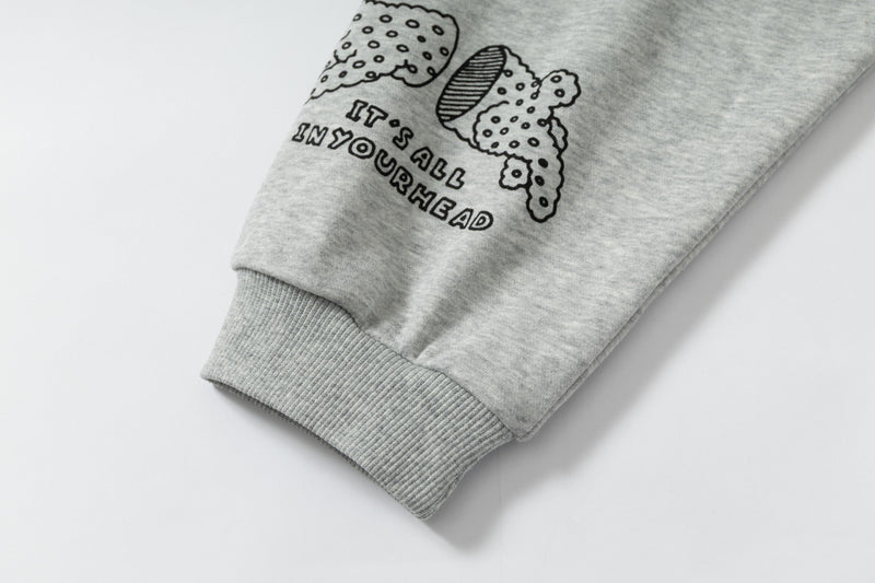 Close-up of sleeve cuff and doodle text on grey hoodie