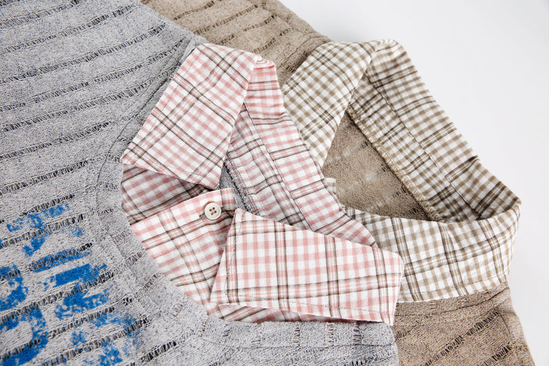 Stack of layered mesh tops showing gray, beige, and plaid collar details