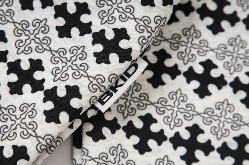 Close-up of patterned hoodie fabric and side seam label