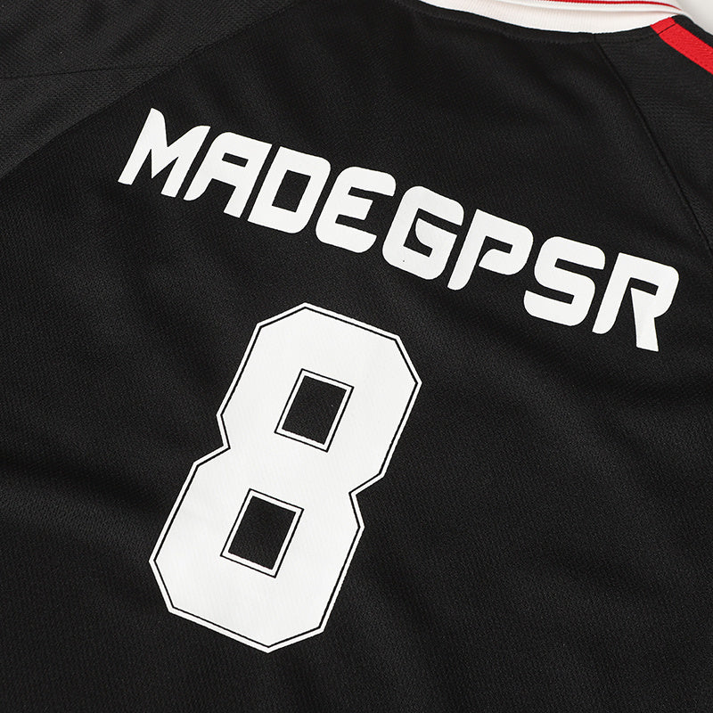 Black football jersey with white MADEGPSR lettering, large number 8, and red shoulder stripes on the back