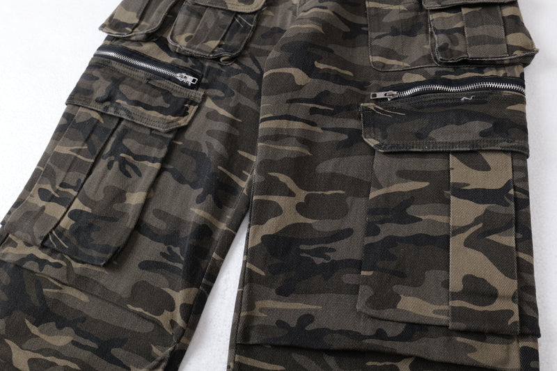 Close-up of front cargo pockets with zipper details on camo pants