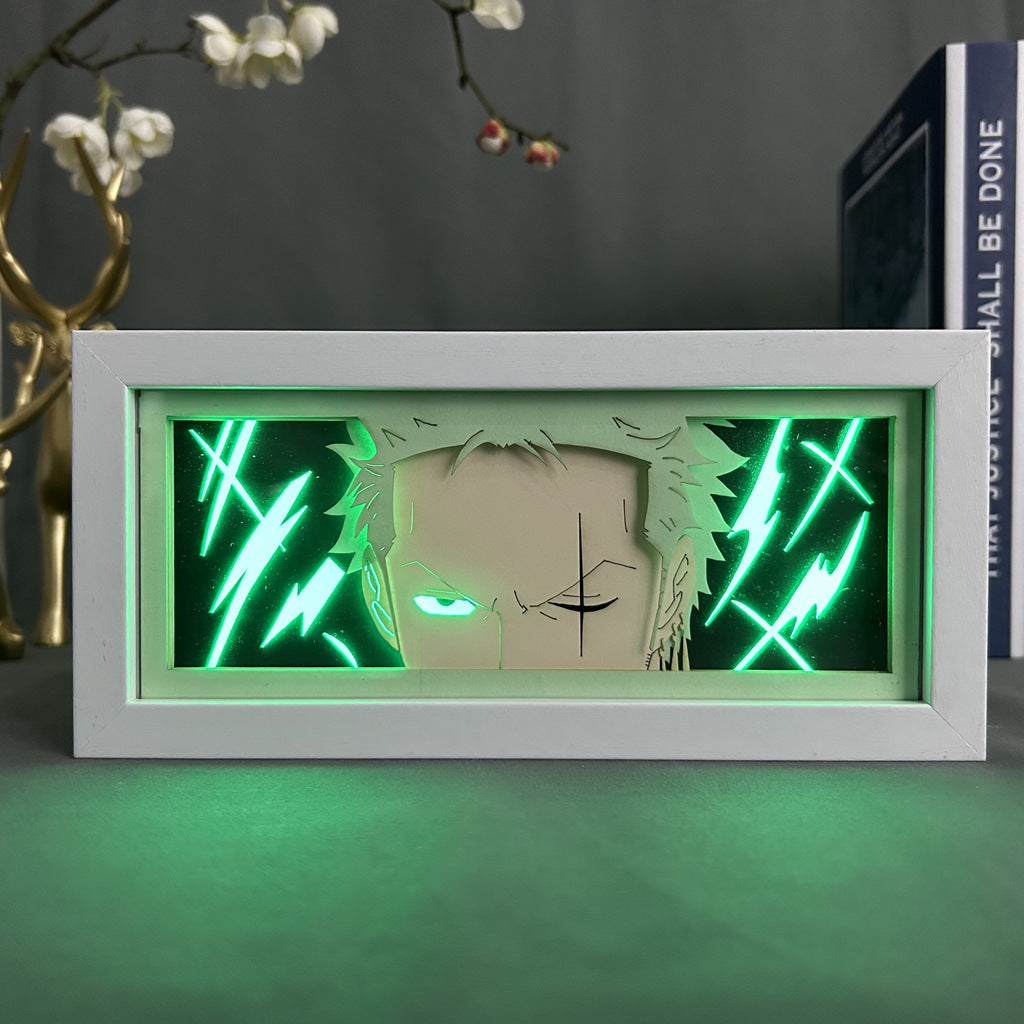 The Seakoff One Piece Anime Light Box features a Roronoa Zoro illustration with vibrant green LED lights and 16 color options. A white frame and 3D effect add depth, while decorative branches enhance its charm.