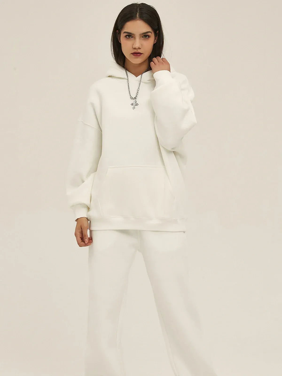 A person wearing the Custom Anime Character White Hoodie - Personalized 350GSM 100% Cotton Pullover with matching white pants stands facing forward against a plain light background.
