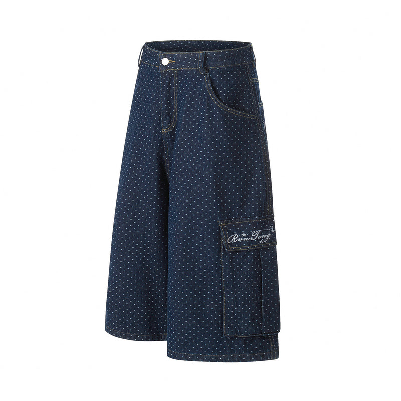 Front view of navy polka dot denim cargo shorts with side cargo pocket and wide-leg fit