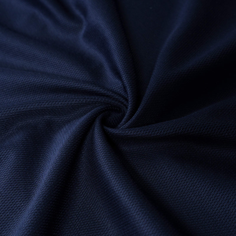 Close-up of navy blue textured cotton fabric with a soft twisted drape and fine knit detail