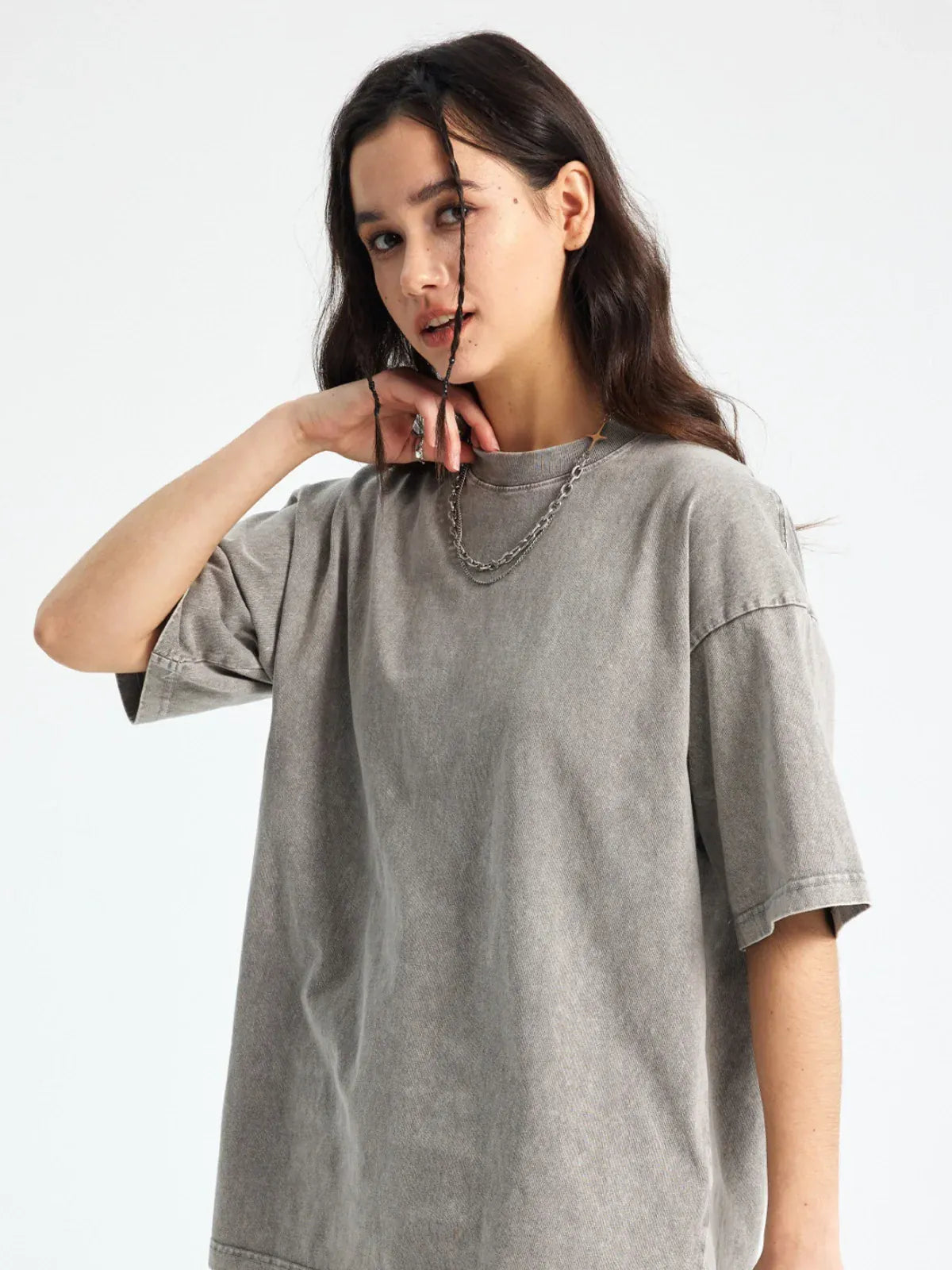 A woman with long dark hair wears the Custom Anime Character Gray Washed T-Shirt - Personalized Anime Style Tee and a silver chain necklace, standing against a plain light background.