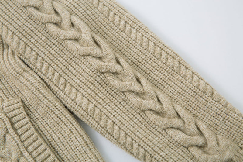Beige cable knit sleeve close-up with twisted braid pattern