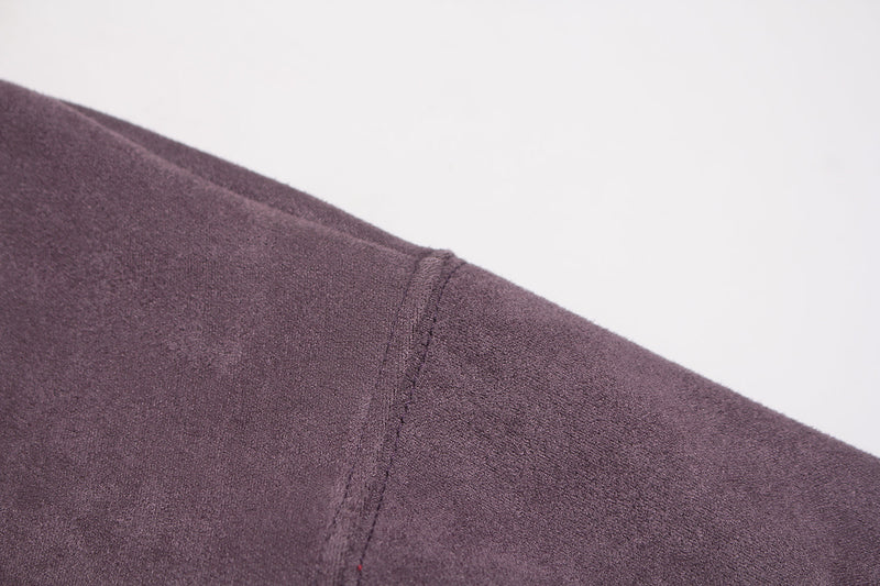 Close-up of seam detail on purple suede hoodie shoulder