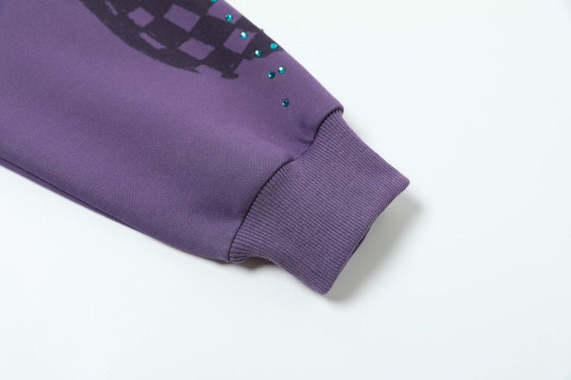 Close-up of purple hoodie sleeve cuff and rhinestone detail