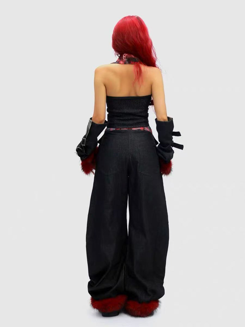 Back view of black barrel leg denim pants worn on model with red faux fur cuffs