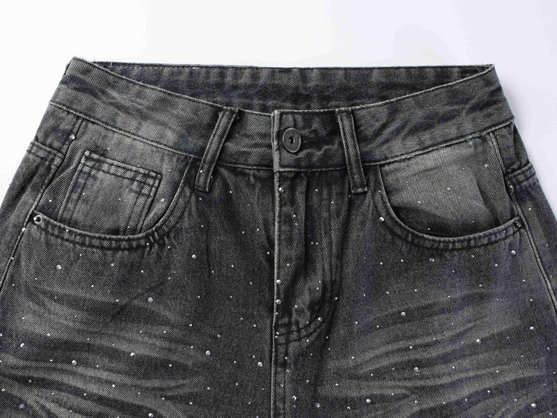 Close-up of front waistband, button, belt loops, and rhinestone-studded black denim