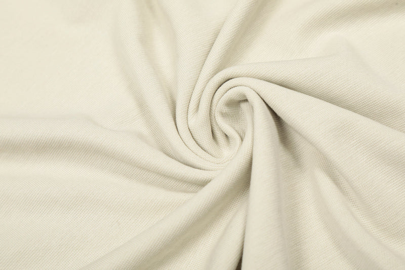 Cream fabric close-up with gathered folds and soft knit texture