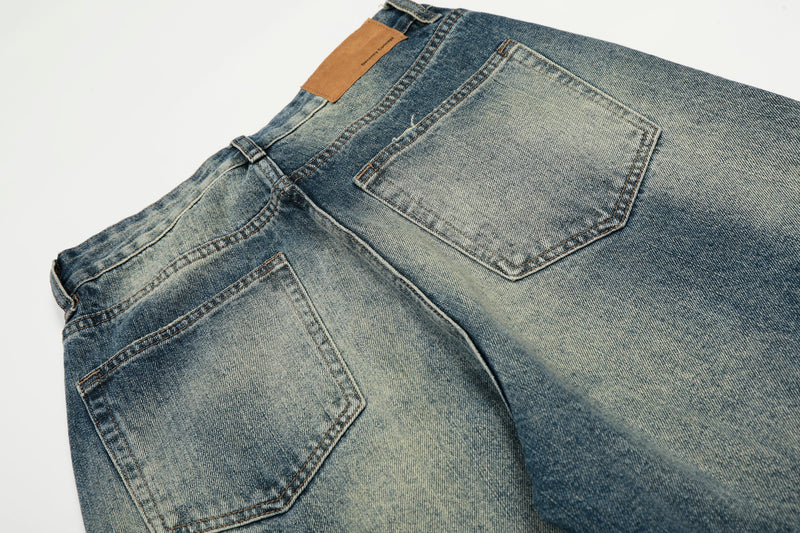 Close-up of the back waistband and pocket on faded blue wide-leg jeans