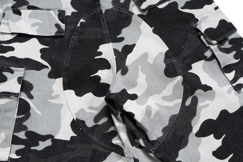 Close-up of camo cargo shorts front panel and curved seam detail