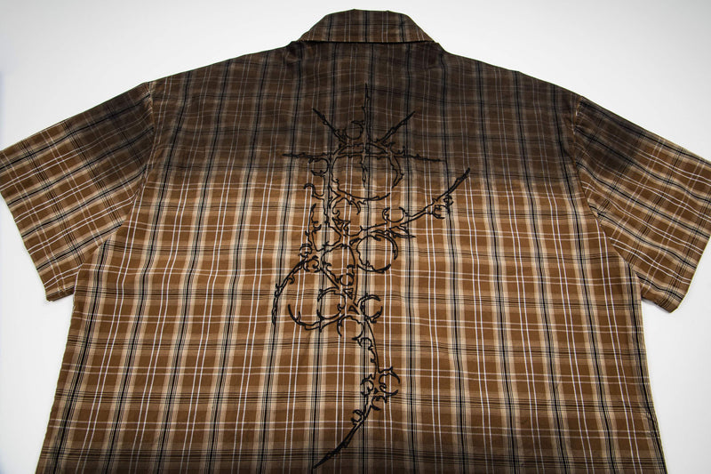 Brown plaid short-sleeve shirt with black abstract graphic on the back, vintage-inspired retro streetwear style