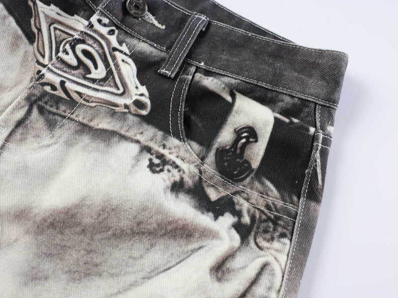Close-up of front pocket area with abstract print and topstitching on denim