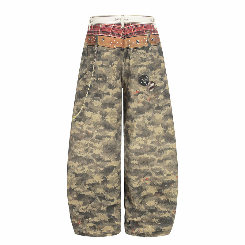 Back view of wide-leg camo patchwork denim pants with plaid yoke and chain detail