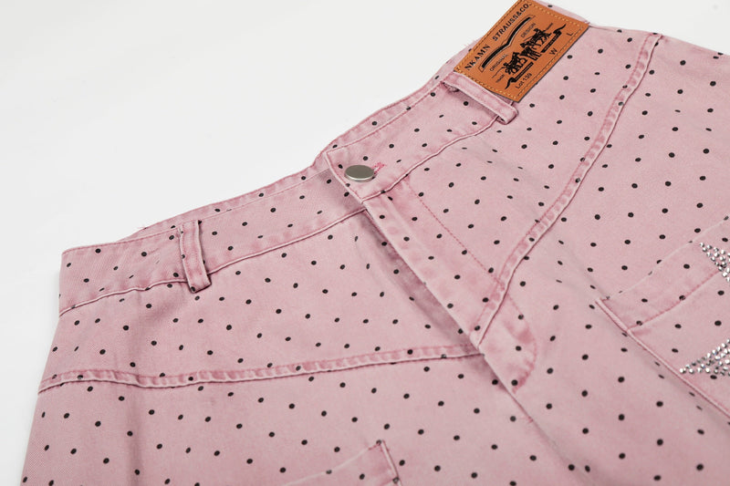 Close-up of waistband and front pocket on pink polka dot pants