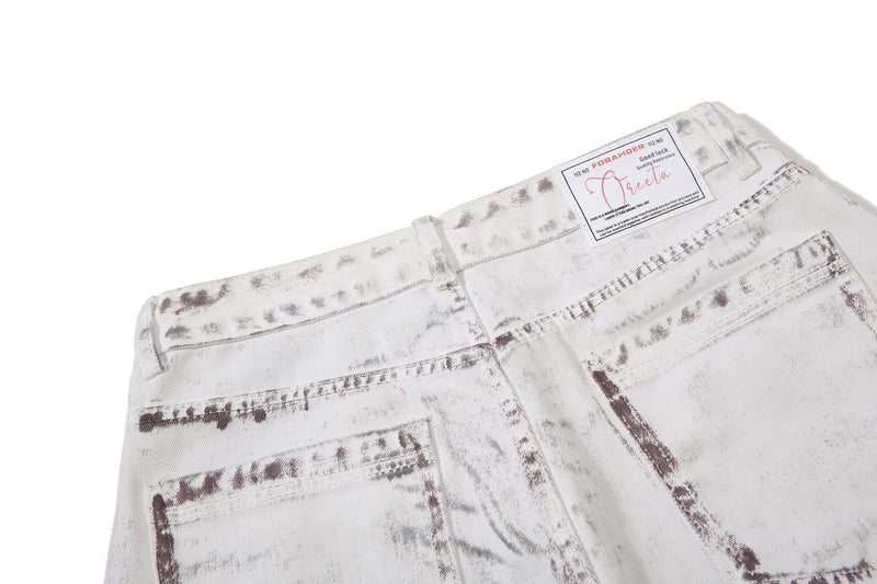 Close-up of back waistband and label on white washed denim pants
