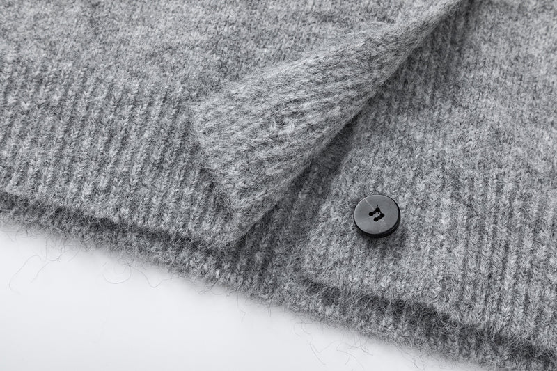 Close-up of gray cardigan cuff and buttoned front hem