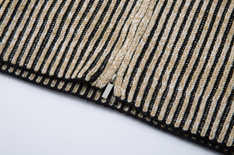 Close-up of the lower front zipper and hem of the striped ribbed knit jacket