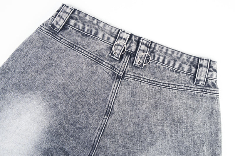 Close-up of the back waistband on gray jeans with ring belt loops and fading