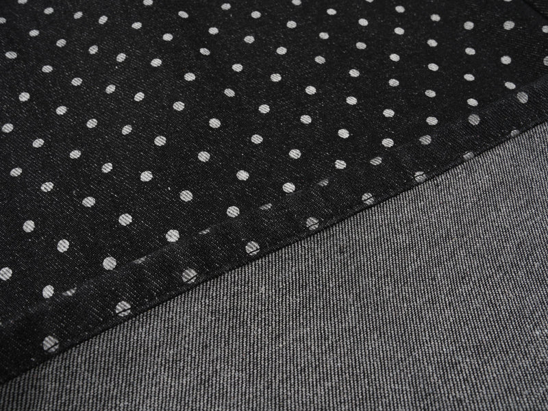 Close-up of black polka-dot denim hem with gray turn-up cuff lining