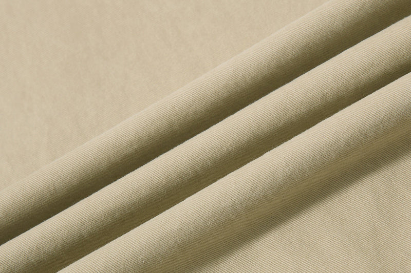 Close-up of beige cotton twill fabric folds and texture