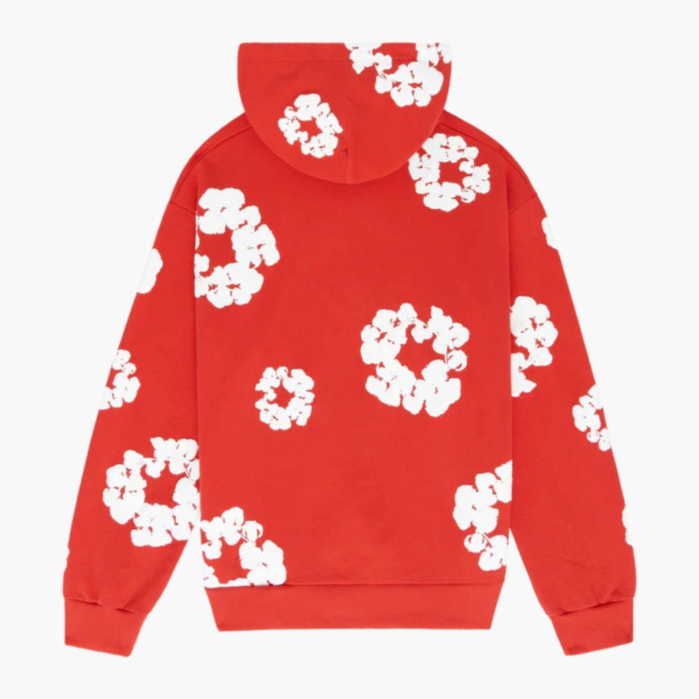 The Red “Cotton Wreath” Denim Tears Hoodie is a vibrant streetwear pullover with a hood, featuring white floral prints scattered on the back and sleeves.