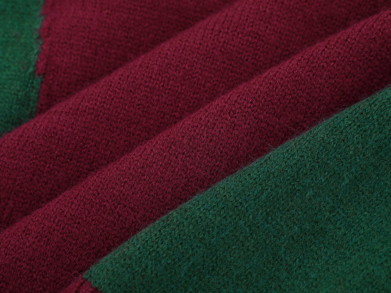 Close-up of burgundy and green knit panels with visible sweater texture
