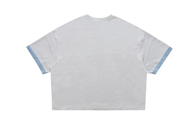 Light gray varsity graphic tee with blue sleeve cuffs and relaxed streetwear fit, shown frontless against a white background