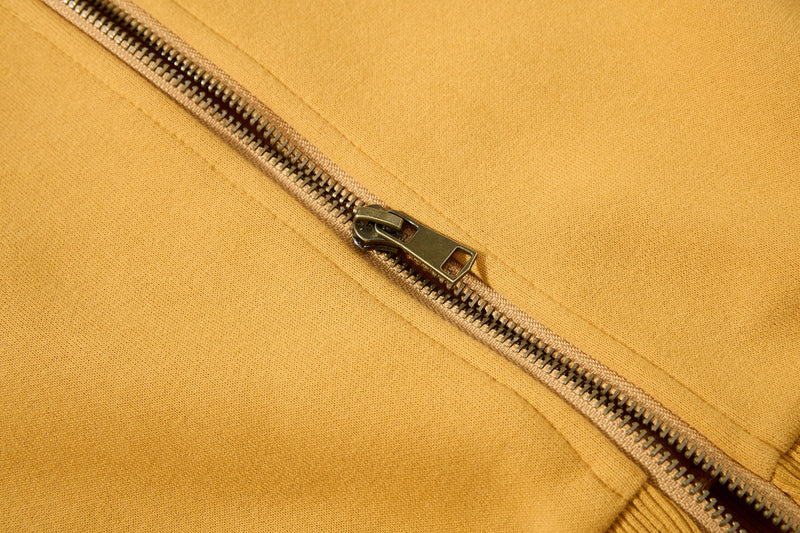 Close-up of mustard yellow zipper on fleece zip-up hoodie