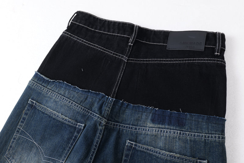 Close-up of black and blue two-tone denim waistband with top stitching and label patch